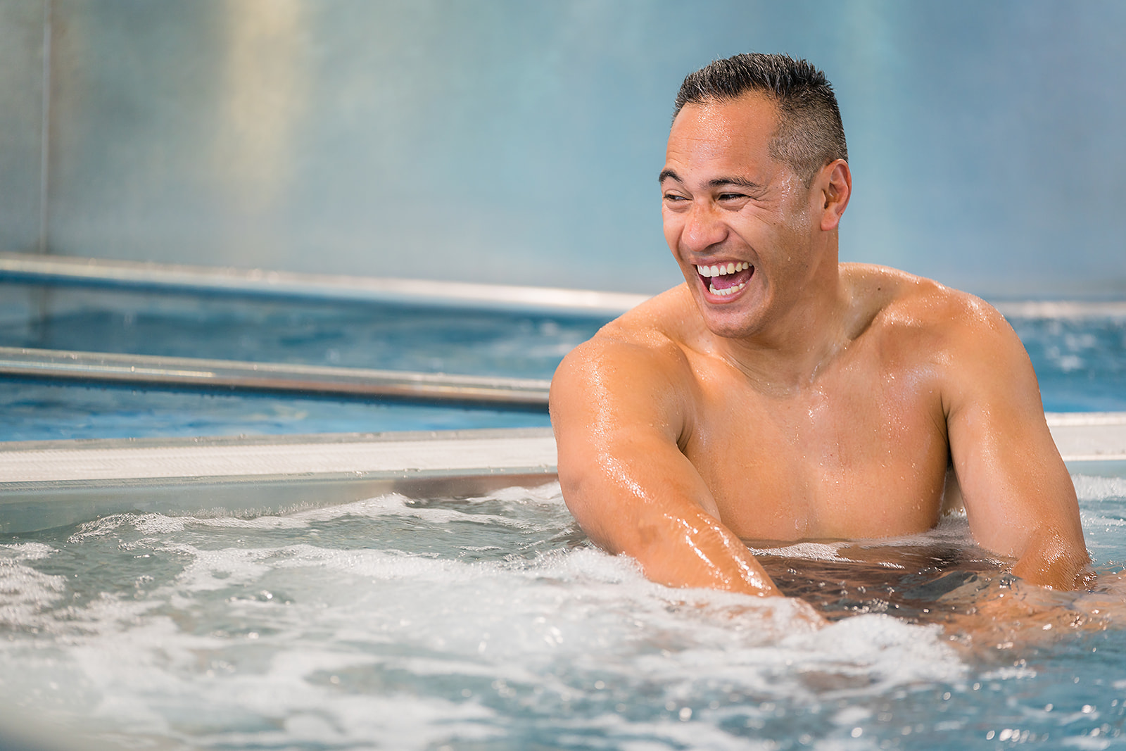 A man laughing in the spa at Christchurch Recreation and Sport pool. 