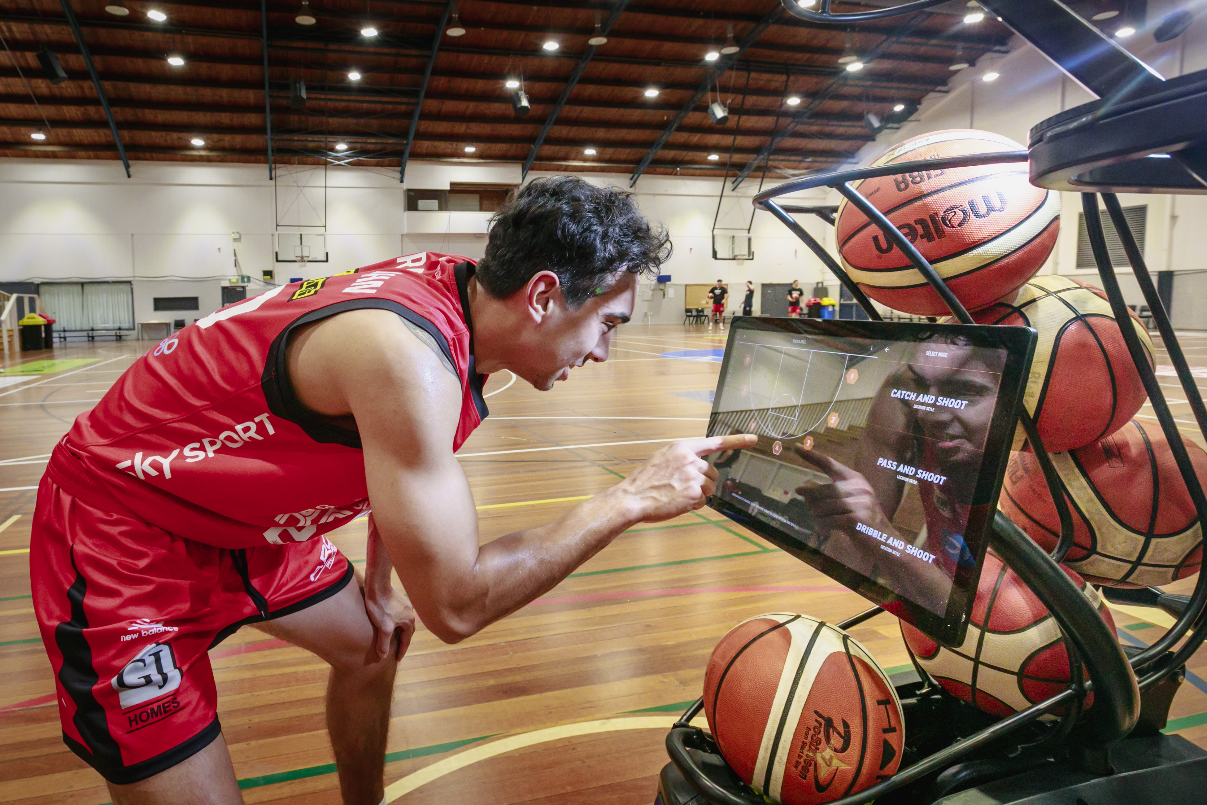 A Canterbury Rams player using a basketball shooting machine at Christchurch Recreation and Sport. 